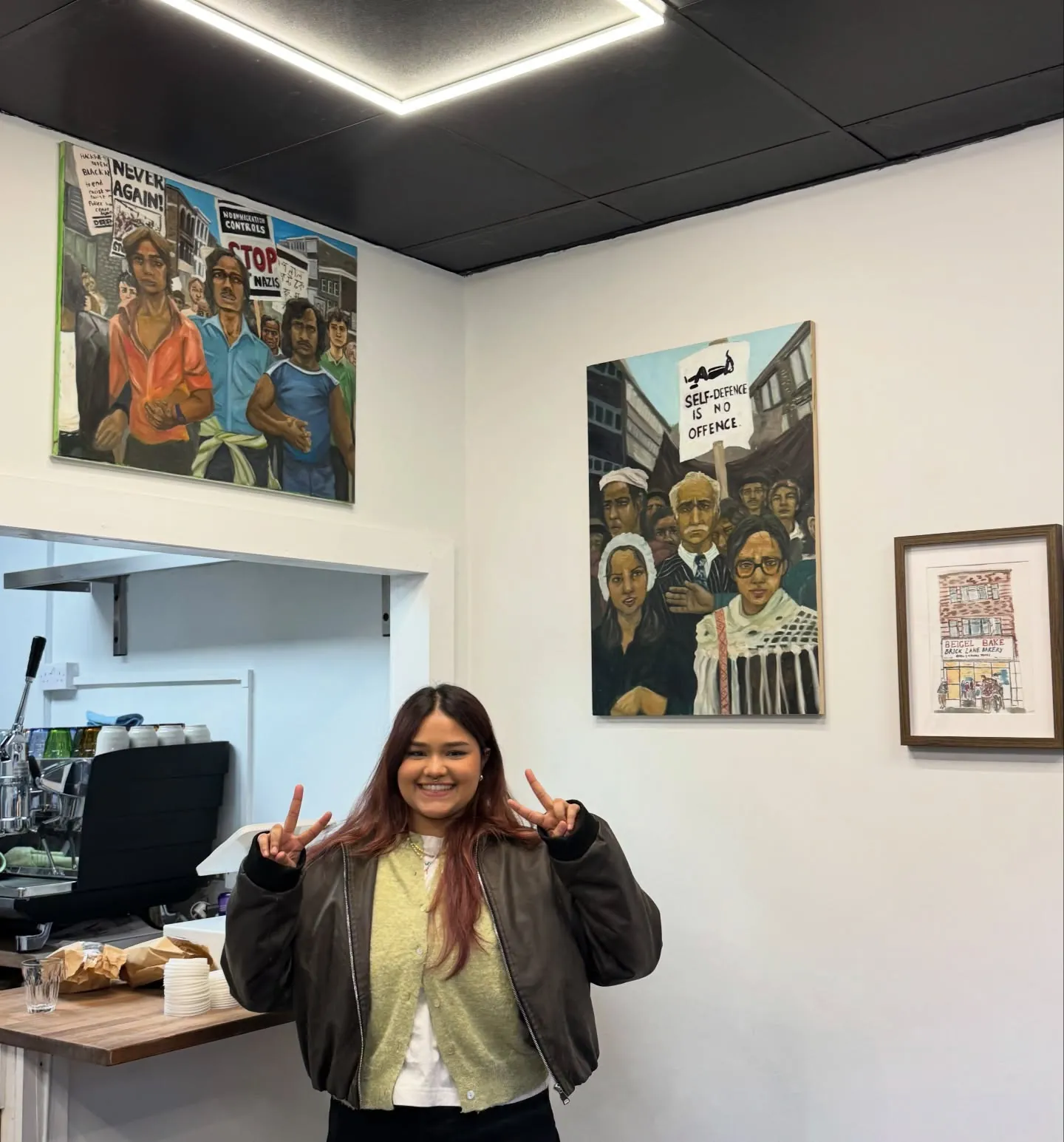 The café wall hung with artwork